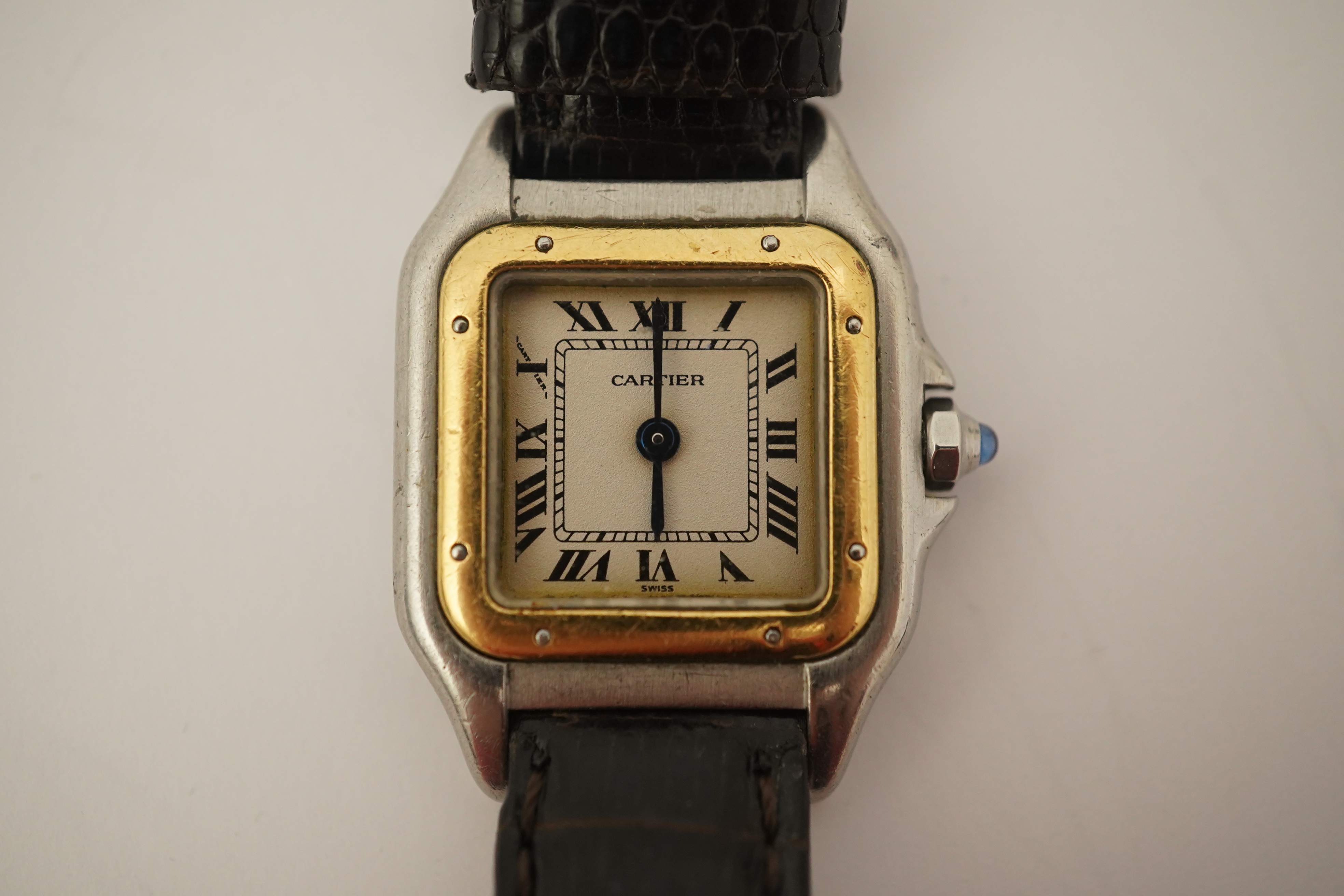 A lady's steel and gold Cartier Panthere quartz wrist watch, now on an associated leather strap, but with original Cartier steel and gold bracelet (lacking end bars)